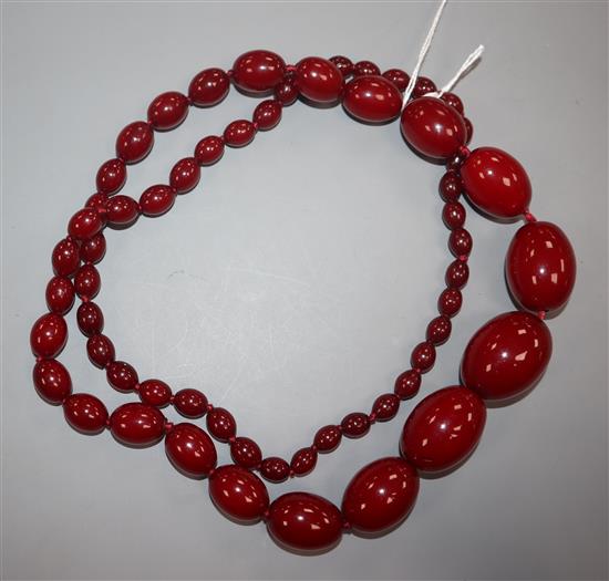 A single strand graduated simulated cherry amber necklace, gross weight 95 grams,